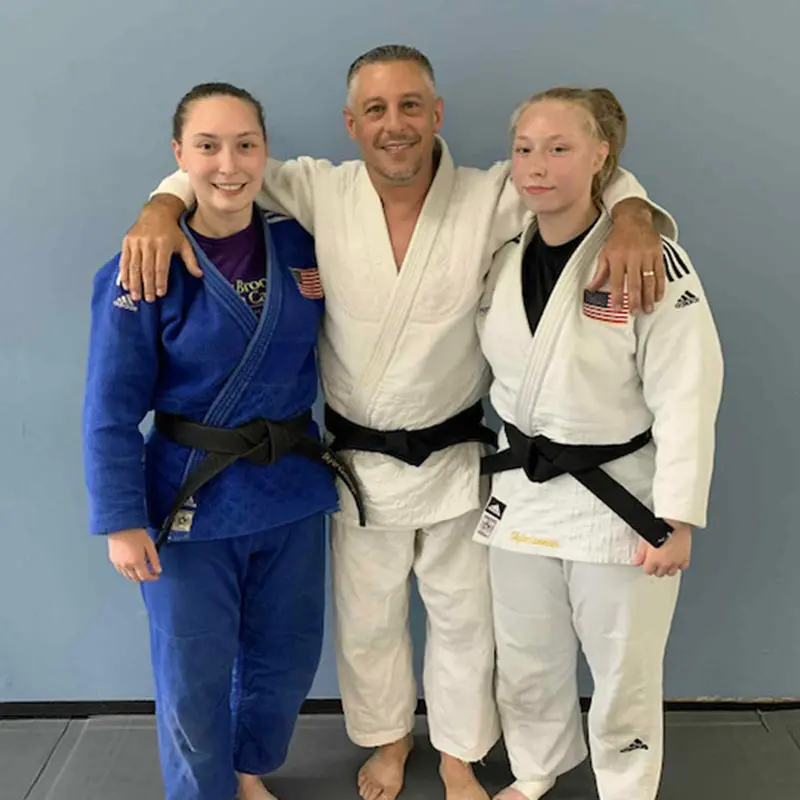 Adult Judo students relaxing and socializing after training in Groton gym